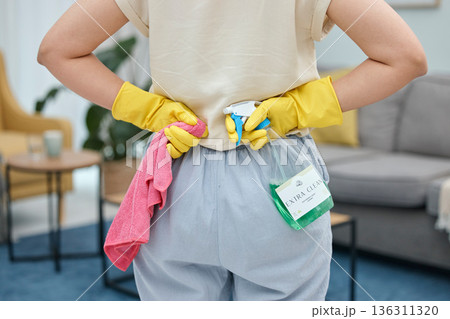 Back of woman, cleaning cloth and bottle with gloves for home disinfection of dirt, bacteria and dust. Closeup hands of female person ready for housekeeping with chemical spray and detergent product 136311320