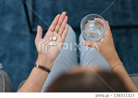 Hands, pills and water in glass with health, sick person and pharmaceutical iron supplement for medical problem. Healthcare, top and pharmacy drugs in palm, pain relief and prescription medicine Hands, pills and water in glass with health, sick person and pharmaceutical iron supplement for medical problem. Healthcare, top and pharmacy drugs in palm, pain relief and prescription medicine 136311323