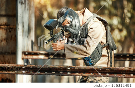 Paintball game, gun shooting and woman focus on player challenge, target aim or military conflict fight. Mission, soldier and female sniper pointing weapon in survival war, action or battle training 136311491