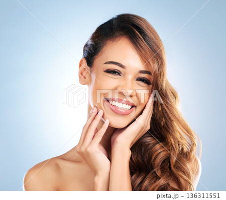 Smile, hair care or happy woman in portrait for beauty, wellness or cosmetics in studio on blue background. Natural hairstyle, beautiful girl or face of model with skincare or healthy glowing skin 136311551