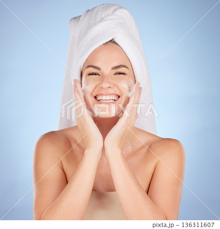 Shower, portrait and woman washing face with soap in studio, blue background and cleaning cosmetics. Happy female model, facial skincare and foam for healthy glow, dermatology and moisturizing beauty 136311607