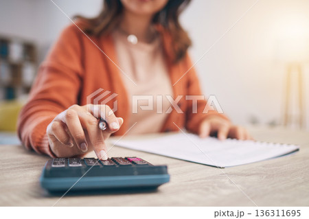 Finance, woman and hands at calculator for budget, taxes report and accounting documents at home. Closeup of person, notes and planning savings, investment money or administration for financial bills Finance, woman and hands at calculator for budget, taxes report and accounting documents at home. Closeup of person, notes and planning savings, investment money or administration for financial bills 136311695