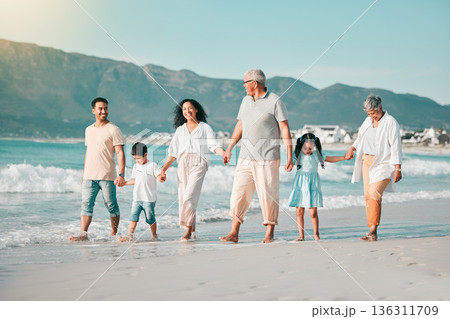 Generations, holding hands and walking family on beach and ocean waves, freedom and bonding in nature. Grandparents, parents and kids, people outdoor and travel with trust and love on Mexican holiday Generations, holding hands and walking family on beach and ocean waves, freedom and bonding in nature. Grandparents, parents and kids, people outdoor and travel with trust and love on Mexican holiday 136311709