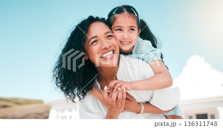 Hug, piggyback and mom with her girl child playing outdoor in the garden at their family home. Happy, smile and young mother carrying her kid on her back bonding and playing together in the backyard. Hug, piggyback and mom with her girl child playing outdoor in the garden at their family home. Happy, smile and young mother carrying her kid on her back bonding and playing together in the backyard. 136311748
