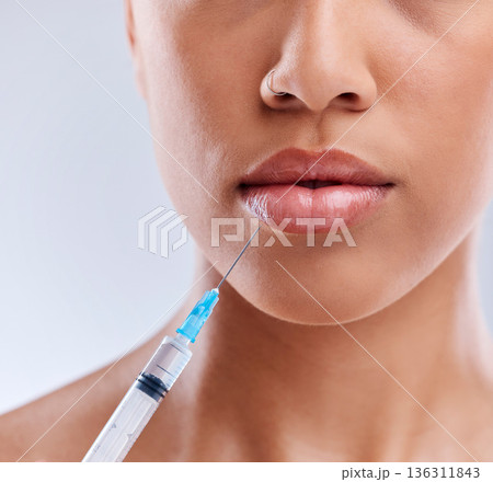 Lip filler, injection and beauty, woman and cosmetic surgery with face closeup isolated on white background. Skincare, liquid collagen and female model, skin and syringe with dermatology in studio 136311843