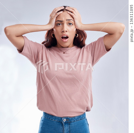 Woman with hands on head, surprise and stress, reaction in portrait with disaster isolated on white background. Crisis, mistake and fail, female person with problem and wow expression in a studio 136311895