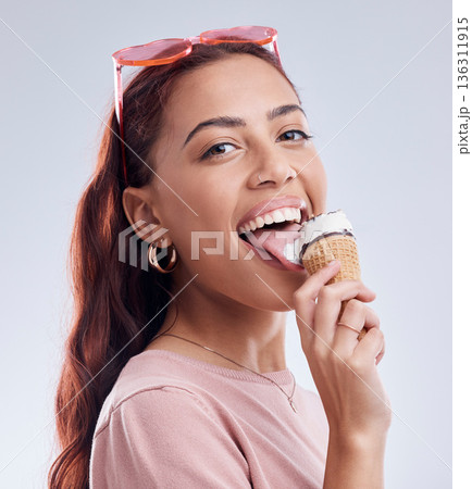 Summer, ice cream and portrait of woman with smile in studio with dessert, snack and sweet treats. Happy, sunglasses and face of female person with cone in trendy accessories, style and cosmetics 136311915