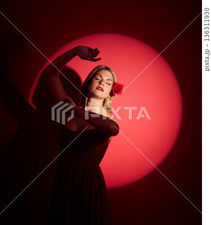 Vintage, creative and a woman in a spotlight on a studio background for an art aesthetic. Fashion, retro and a young girl or rich model in a stylish dress or clothes isolated on a red backdrop Vintage, creative and a woman in a spotlight on a studio background for an art aesthetic. Fashion, retro and a young girl or rich model in a stylish dress or clothes isolated on a red backdrop 136311930