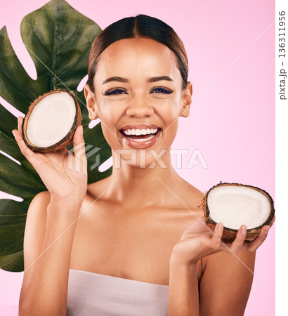Woman, smile and coconut, natural beauty and palm leaf with sustainable skincare isolated on pink background. Happiness, female model with fruit and eco friendly dermatology, cosmetic care in studio Woman, smile and coconut, natural beauty and palm leaf with sustainable skincare isolated on pink background. Happiness, female model with fruit and eco friendly dermatology, cosmetic care in studio 136311956