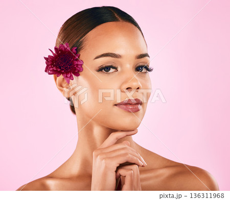 Skincare, beauty and portrait of woman with flower, makeup and organic glow on pink background. Cosmetics, natural dermatology and model with facial care, nature and healthy spa aesthetic in studio. Skincare, beauty and portrait of woman with flower, makeup and organic glow on pink background. Cosmetics, natural dermatology and model with facial care, nature and healthy spa aesthetic in studio. 136311968