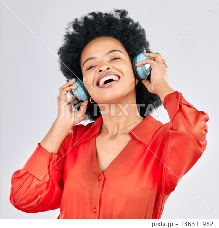 Music, headphones or happy black woman listening to radio playlist to relax on white background in studio. Hearing, freedom or African person dancing, smiling or streaming a song audio or sound track 136311982
