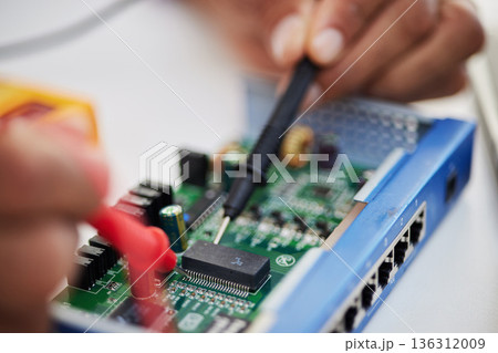 Motherboard, hands and technology with microchip, engineering and repair closeup. IT, hardware and electrical person working on maintenance, problem solving and circuit check of battery with tools 136312009