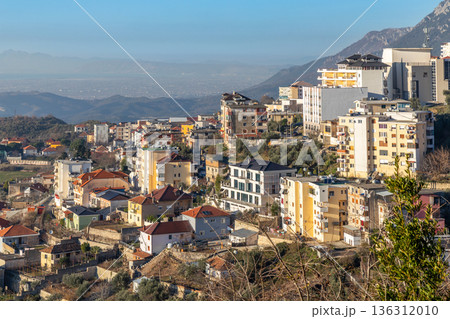Panoramic view of a hillside residential district with traditional and modern buildings with mountain Balkan landscape, Kruja, Albania 136312010