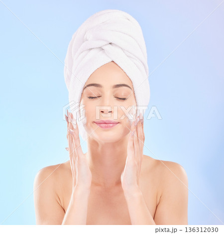 Face, skincare and woman with soap, towel and isolated in studio on a blue background. Eyes closed, cosmetic and model washing, cleaning or hygiene with facial foam for health, dermatology or beauty Face, skincare and woman with soap, towel and isolated in studio on a blue background. Eyes closed, cosmetic and model washing, cleaning or hygiene with facial foam for health, dermatology or beauty 136312030