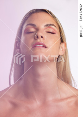 Face, beauty and skincare with a model woman in studio on a gray background in ambient lighting for feminine desire. Luxury, makeup or cosmetics with a young person posing eyes closed for wellness Face, beauty and skincare with a model woman in studio on a gray background in ambient lighting for feminine desire. Luxury, makeup or cosmetics with a young person posing eyes closed for wellness 136312032