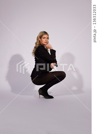 Fashion, stylish and portrait of a woman on a studio background for edgy aesthetic. Trendy, fashionable and a model or girl in a suit with elegance and clothes isolated on a backdrop for confidence 136312033