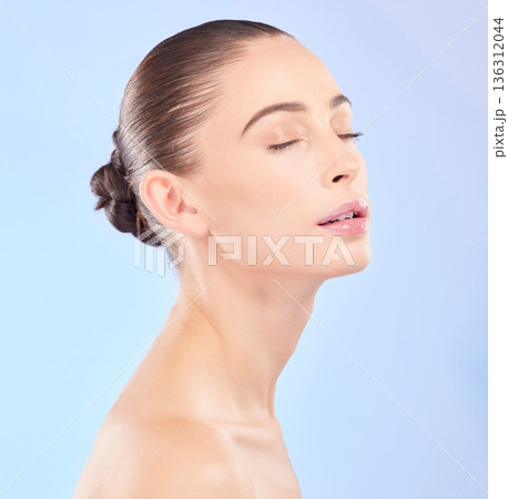 Woman, natural beauty and eyes closed in studio, blue background or facial wellness. Face, calm and young female model for skincare glow, aesthetic dermatology or cosmetics of self love, spa or shine 136312044