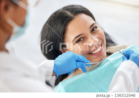 Dentist, dental care and teeth smile of a woman with tools and hands of a professional by mouth. Portrait of a female patient for orthodontics, healthcare and cleaning or inspection for oral health Dentist, dental care and teeth smile of a woman with tools and hands of a professional by mouth. Portrait of a female patient for orthodontics, healthcare and cleaning or inspection for oral health 136312046