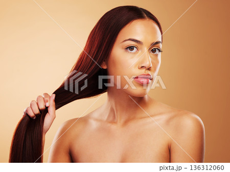 Portrait, haircare and beauty, woman with strong hair and luxury salon treatment on brown background. Natural glow, haircut and keratin growth, serious face of model in cosmetics and makeup studio. 136312060
