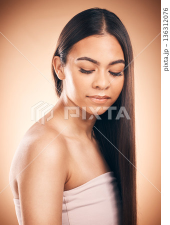 Beauty, makeup and hair with face of woman in studio for self care, cosmetics and glow. Skincare, spa and salon treatment with female model on brown background for wellness, hairstyle and shampoo 136312076