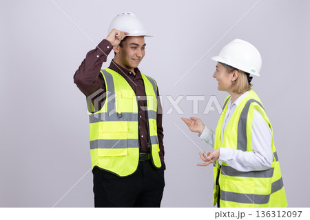 Engineer and builder in safety gear having conversation Engineer and builder in safety gear having conversation 136312097