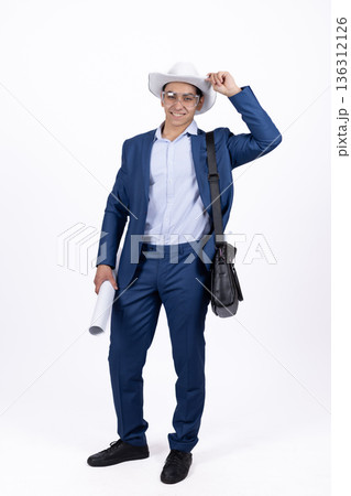 Young man in blue suit holding a blazer over his shoulder Young man in blue suit holding a blazer over his shoulder 136312126