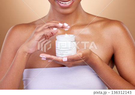 Cream, container and woman hands for skincare, beauty and cosmetics application on brown background. Happy person or skin care model with body lotion or moisturizer for dermatology health in studio Cream, container and woman hands for skincare, beauty and cosmetics application on brown background. Happy person or skin care model with body lotion or moisturizer for dermatology health in studio 136312143