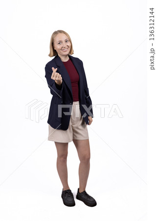 Businesswoman in blazer pointing at camera with finger 136312144