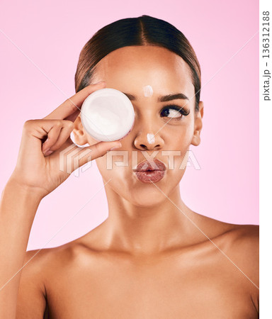 Beauty, cream and portrait of woman with skincare and cosmetics for facial care, dermatology or treatment on pink background. Face, happy and healthy girl with product, lotion or moisturizer on skin 136312188