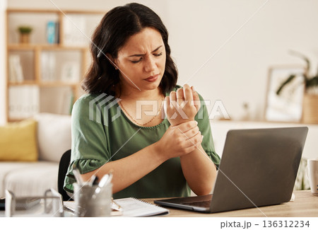 Remote work from home, laptop and woman with wrist pain, injury and overworked by desk. Female person, entrepreneur or freelancer with a pc, carpal tunnel syndrome and ache with sprain hand and joint 136312234