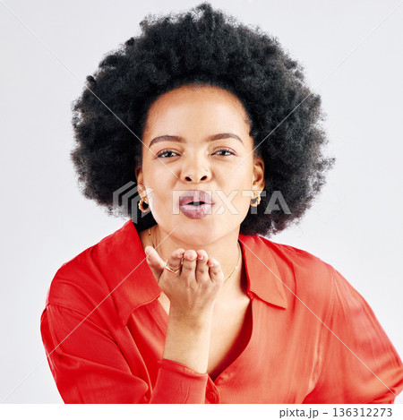 Portrait, happy and black woman blowing a kiss, flirty and seductive against a white studio background. Face, female person or model being alluring, kissing or love with romantic gesture or happiness Portrait, happy and black woman blowing a kiss, flirty and seductive against a white studio background. Face, female person or model being alluring, kissing or love with romantic gesture or happiness 136312273