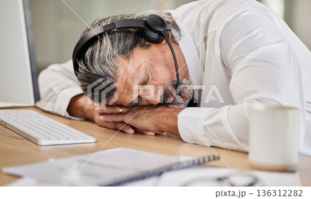 Tired, customer service and male agent sleeping in his office while doing online consultation. Exhausted, burnout and mature man telemarketing or call center consultant taking a nap in the workplace. Tired, customer service and male agent sleeping in his office while doing online consultation. Exhausted, burnout and mature man telemarketing or call center consultant taking a nap in the workplace. 136312282