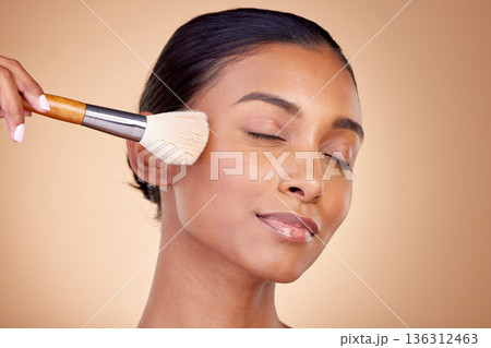 Beauty, makeup and relax with woman and brush in studio for facial, foundation and self care. Cosmetics, product and tools with face of model on brown background for glow, skincare and dermatology Beauty, makeup and relax with woman and brush in studio for facial, foundation and self care. Cosmetics, product and tools with face of model on brown background for glow, skincare and dermatology 136312463