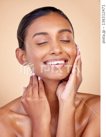 Face, skincare or happy woman with natural beauty or facial glow with dermatology cosmetics in studio. Eyes closed, relax or beautiful Indian girl model laughing with wellness, smile or self love Face, skincare or happy woman with natural beauty or facial glow with dermatology cosmetics in studio. Eyes closed, relax or beautiful Indian girl model laughing with wellness, smile or self love 136312471