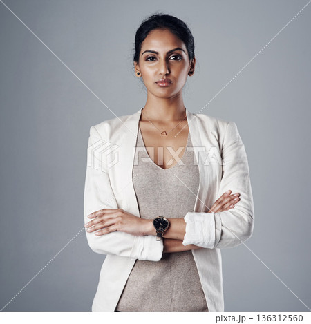 Confidence, portrait of a businesswoman with her arms crossed and against a studio background for elegance, Assertive or proud, professional or leadership and female person pose for empowerment 136312560