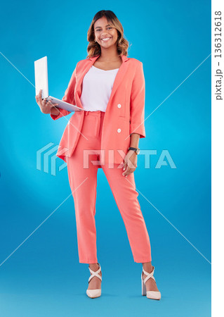 Computer, fashion and business woman for online marketing, social media planning or copywriting portrait in studio. E commerce, designer suit and full body of person on a laptop and blue background Computer, fashion and business woman for online marketing, social media planning or copywriting portrait in studio. E commerce, designer suit and full body of person on a laptop and blue background 136312618