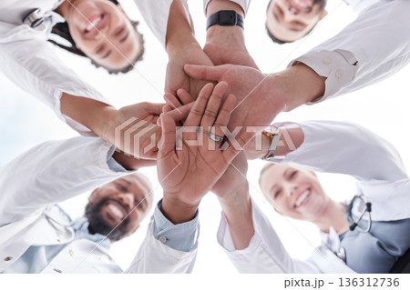 Hospital doctors, happy people and circle hands together for healthcare teamwork, medical team building and clinic celebration. Solidarity, below view and group surgeon for collaboration success Hospital doctors, happy people and circle hands together for healthcare teamwork, medical team building and clinic celebration. Solidarity, below view and group surgeon for collaboration success 136312736