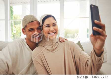 Selfie, Islam and happy couple on couch with smile, culture and love in living room in Indonesia. Marriage, man and woman in hijab on sofa together with respect, religion and photo for social media. 136312757