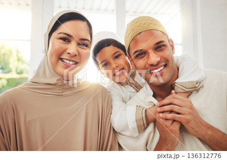 Portrait, hug and happy muslim family of mother, father and child smile, bond and enjoy quality time together. Living room, home happiness and face of Islamic mom, kid and Arabic dad embrace for love Portrait, hug and happy muslim family of mother, father and child smile, bond and enjoy quality time together. Living room, home happiness and face of Islamic mom, kid and Arabic dad embrace for love 136312776