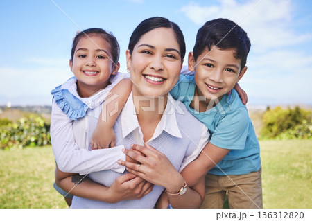 Happy mother, portrait and hug with kids in nature for quality time, bonding or love together outdoors. Mom, smile and children in piggyback enjoying summer weekend, holiday or vacation in the park Happy mother, portrait and hug with kids in nature for quality time, bonding or love together outdoors. Mom, smile and children in piggyback enjoying summer weekend, holiday or vacation in the park 136312820