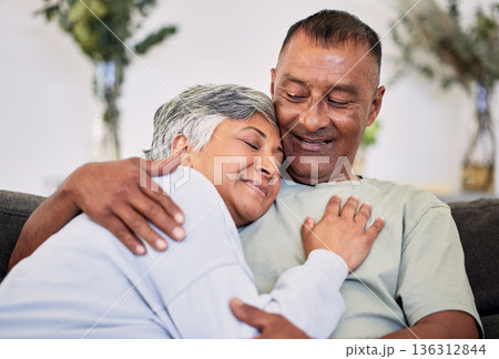 Retirement, love and care with mature couple on sofa to relax in family home for bond. Marriage, smile and senior man or woman in living room for rest or calm with happiness for relationship together Retirement, love and care with mature couple on sofa to relax in family home for bond. Marriage, smile and senior man or woman in living room for rest or calm with happiness for relationship together 136312844