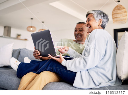 Mature couple, laptop and relax on sofa in living room, download media and choice of watching movie together. Happy man, woman and computer for streaming online video, web subscription and internet Mature couple, laptop and relax on sofa in living room, download media and choice of watching movie together. Happy man, woman and computer for streaming online video, web subscription and internet 136312857