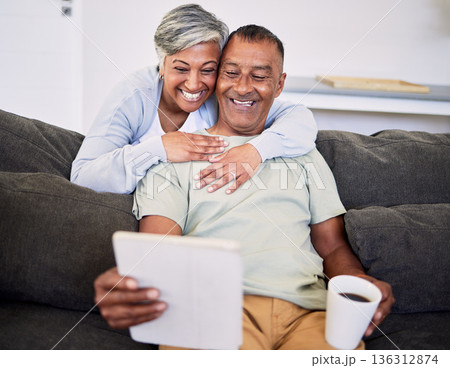Video call, happy and senior couple with a tablet on a sofa while relaxing and bonding together. Smile, love and elderly man and woman in retirement on a virtual conversation with digital technology. Video call, happy and senior couple with a tablet on a sofa while relaxing and bonding together. Smile, love and elderly man and woman in retirement on a virtual conversation with digital technology. 136312874