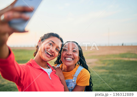 Selfie, happy and friends in nature for social media memory, update or together in summer. Smile, diversity and women taking a digital photo at a park for travel, vacation or relax on a holiday Selfie, happy and friends in nature for social media memory, update or together in summer. Smile, diversity and women taking a digital photo at a park for travel, vacation or relax on a holiday 136312889
