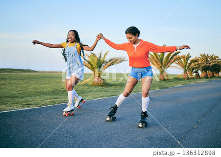Roller skates, holding hands and friends on street for workout, exercise or training outdoor. Skating, happy people and girls together for sports on road to travel, journey and moving for fitness. Roller skates, holding hands and friends on street for workout, exercise or training outdoor. Skating, happy people and girls together for sports on road to travel, journey and moving for fitness. 136312898
