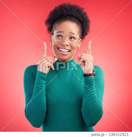 Looking up, black woman and hand pointing in studio for announcement, deal or promotion on red background. Finger, smile and African female show news, sale and competition info, giveaway or vote Looking up, black woman and hand pointing in studio for announcement, deal or promotion on red background. Finger, smile and African female show news, sale and competition info, giveaway or vote 136312921