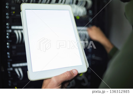 Screen, technician and hands with tablet for information on a server room for network analytics. Closeup, working and a programmer with mockup technology for system connectivity, coding and research Screen, technician and hands with tablet for information on a server room for network analytics. Closeup, working and a programmer with mockup technology for system connectivity, coding and research 136312985