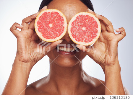 Smile, face and senior woman with grapefruit in studio isolated on a white background. Skincare, natural fruit and happy model with food for nutrition, healthy diet and vitamin c for anti aging. Smile, face and senior woman with grapefruit in studio isolated on a white background. Skincare, natural fruit and happy model with food for nutrition, healthy diet and vitamin c for anti aging. 136313180