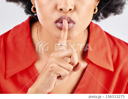 Secret, hands and woman with finger on lips in studio for sign of privacy on white background. Closeup face of female model, silence and shush for quiet, gossip or whisper emoji for confidential news 136313275