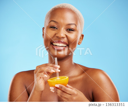 Happy black woman, portrait and orange for vitamin C, diet or natural nutrition against a blue studio background. African female person smile with citrus fruit and straw for healthy wellness or juice Happy black woman, portrait and orange for vitamin C, diet or natural nutrition against a blue studio background. African female person smile with citrus fruit and straw for healthy wellness or juice 136313351